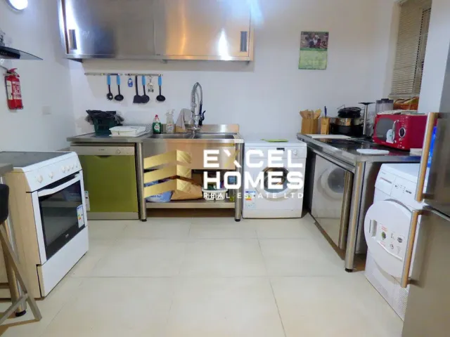 a kitchen with a stove, microwave, refrigerator and a sink