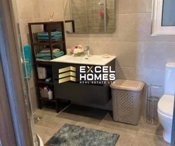 a bathroom with a toilet, sink, and a mirror 