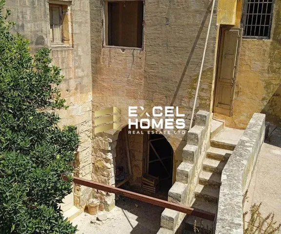 a building with a stairway leading to a tunnel