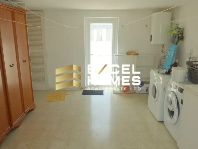 a kitchen with a refrigerator, stove, sink and a window 