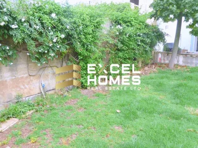 a wall with a picture of a plant and a sign 