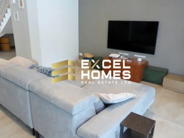 a living room with a couch, coffee table and a television 
