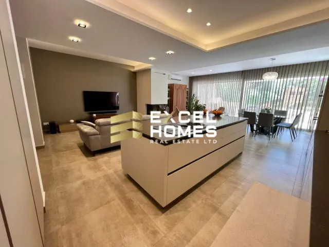 a living room with a large window and a large table 