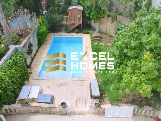a pool with a pool table and a fence 