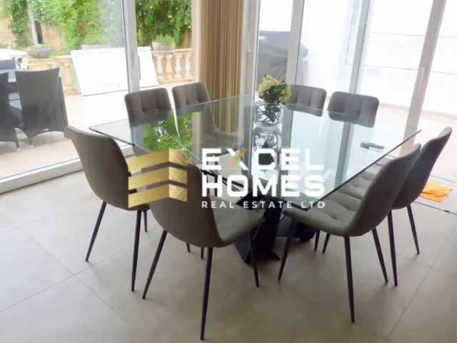 a dining room table with chairs and a table with a glass table 