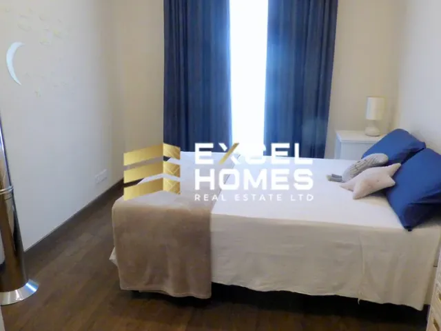 a bed with a white blanket and pillows on it 