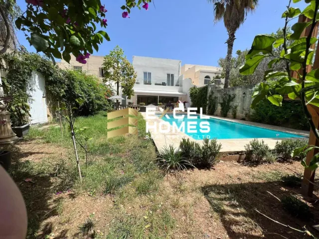 a house with a pool and a lawn 