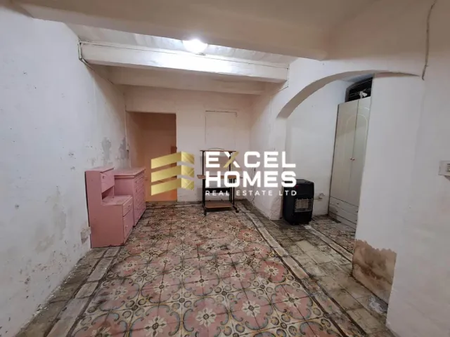 a room with a door open and a pile of luggage