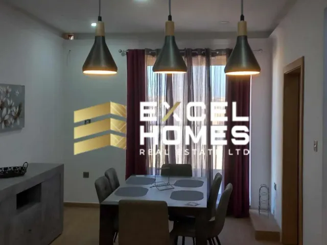 a kitchen with a table and chairs and a lamp