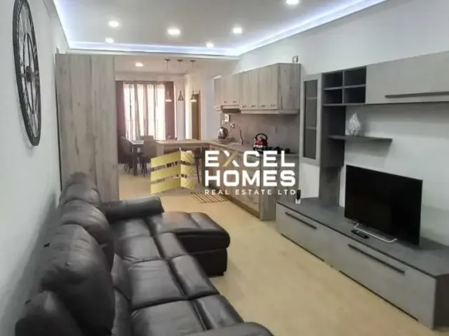 a living room with a couch, coffee table and television