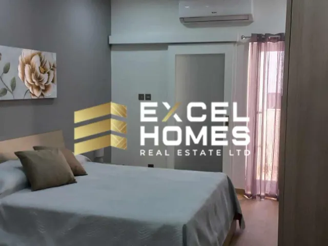 a bedroom with a bed, a desk and a lamp