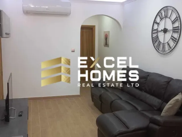 a living room with a couch, coffee table and a television