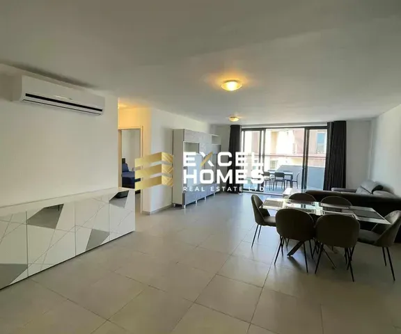a kitchen with a table and chairs and a refrigerator