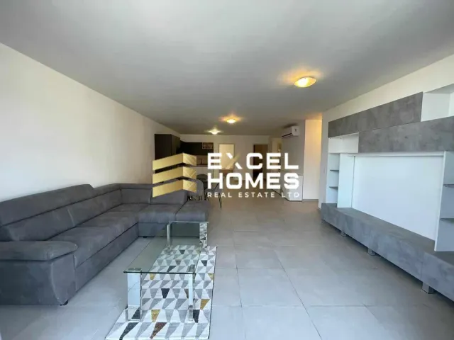 a living room with a couch, coffee table and a television