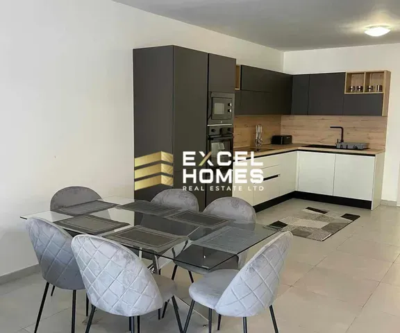 a kitchen with a table and chairs and a refrigerator