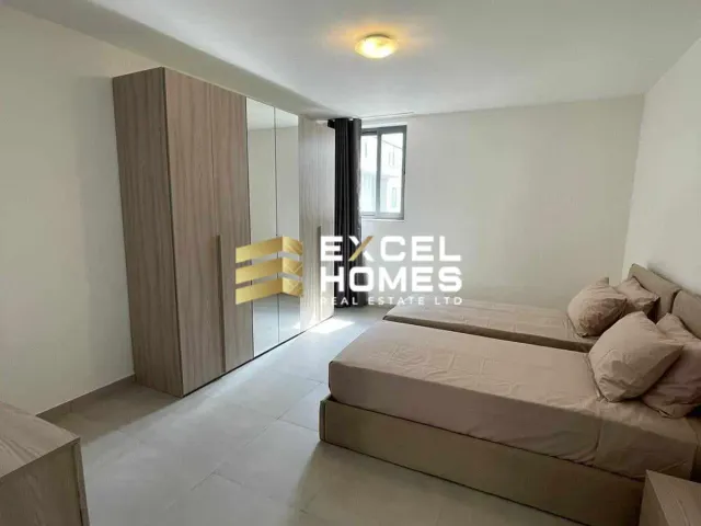 a bedroom with a bed, a dresser and a mirror
