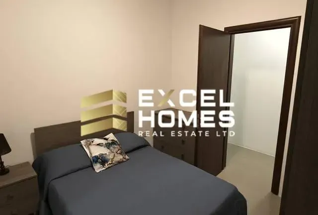 a dog laying on a bed in a bedroom