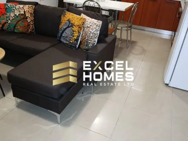 a living room with a couch, coffee table, and a television