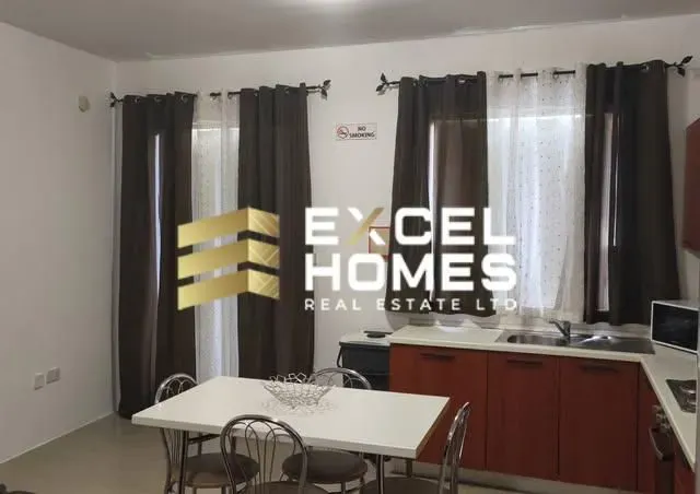 a kitchen with a table and chairs and a window