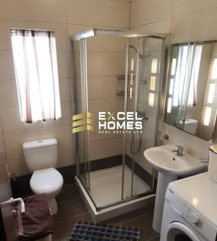 a bathroom with a toilet, sink, and shower