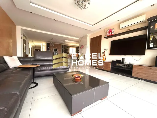 a living room with a couch, coffee table and a television