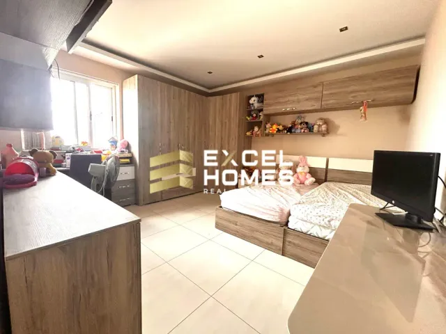 a living room with a couch, chair, and a television