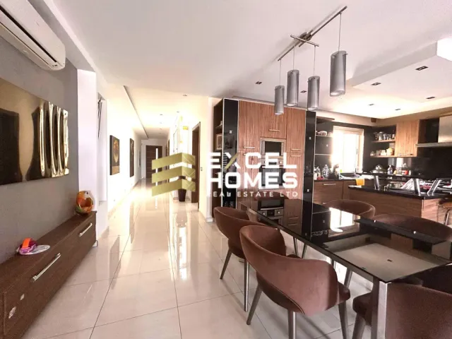 a kitchen with a table and chairs and a refrigerator