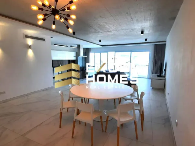 a dining room with a table and chairs