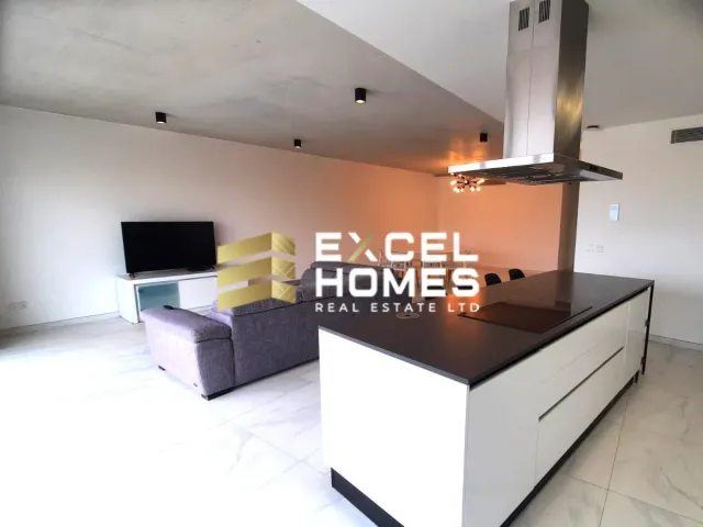 a living room with a couch, coffee table and a television