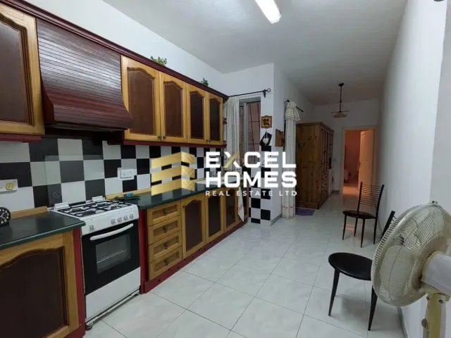 a kitchen with a stove, sink, and refrigerator