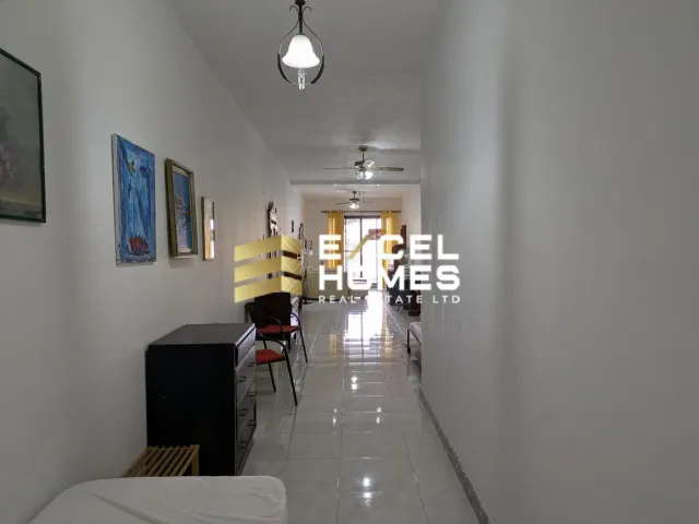 a person walking down a hallway with a suitcase