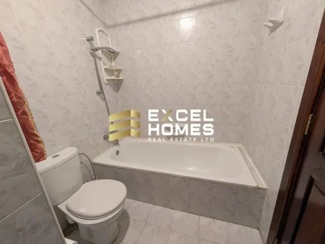 a bathroom with a toilet, sink, and bathtub
