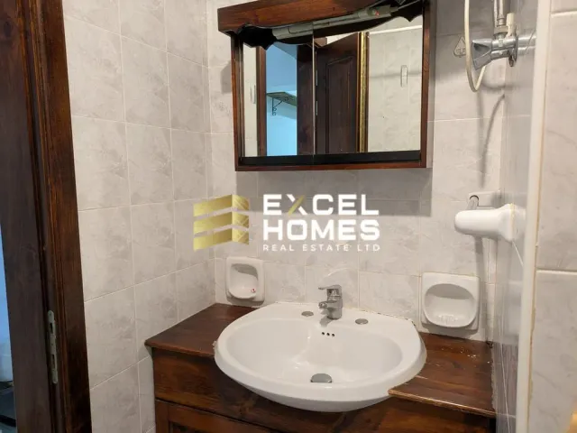 a bathroom sink with a mirror and a towel rack