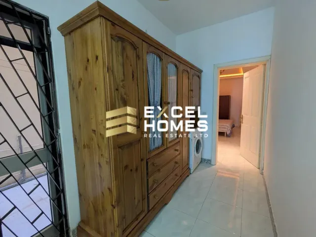 a room with a wooden door and a wooden cabinet