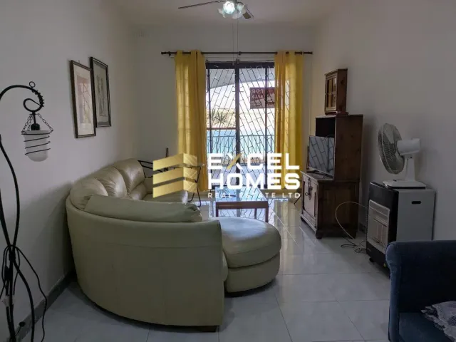 a living room with a couch, chair, and a television