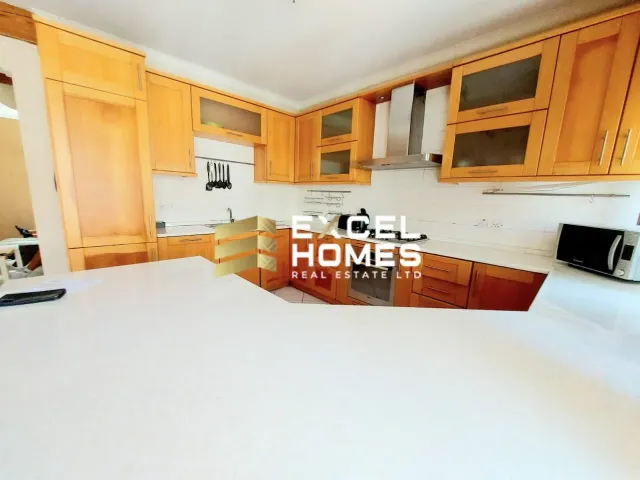 a kitchen with a stove, sink, cabinets and a refrigerator