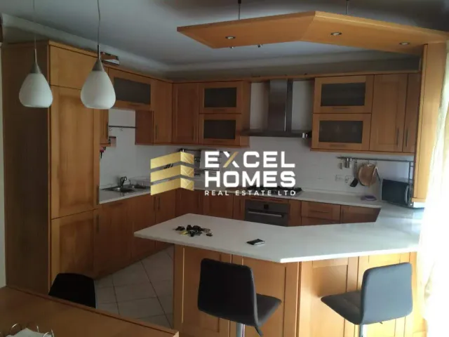 a kitchen with a sink, microwave, and a refrigerator