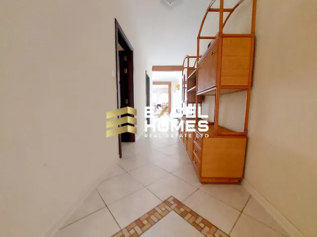 a room with a wooden floor and a wall with a door