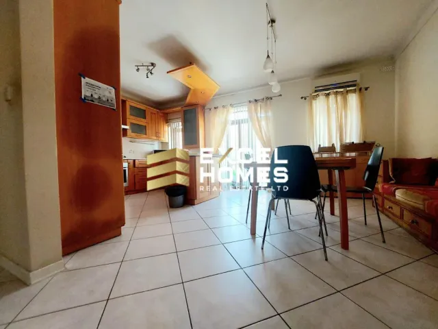 a room with a table and chairs and a door