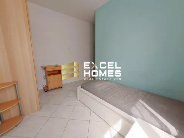 a bathroom with a white rug and a blue wall