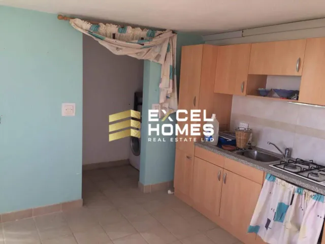 a kitchen with a sink, stove, and a window