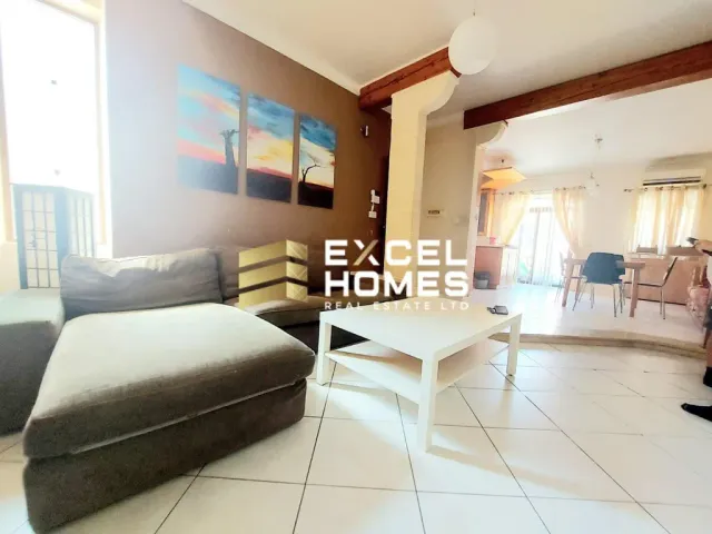 a living room with a couch, chair, and a table