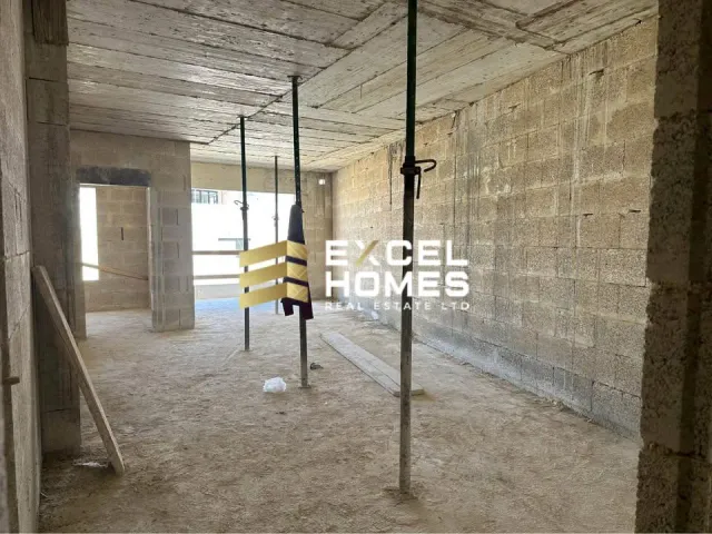 a man standing in a room with a wall