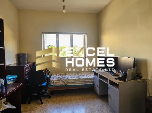 a room with a desk and a computer on it 