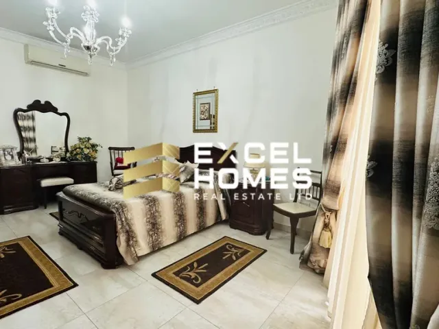 a living room with a couch, table, and a rug
