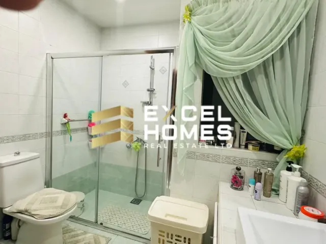 a bathroom with a shower, toilet, and sink