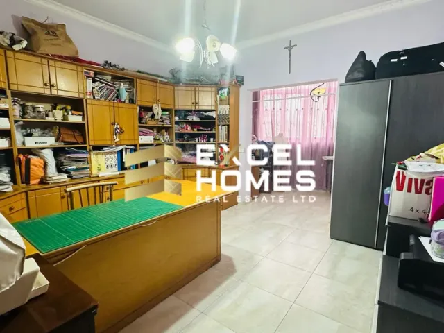 a kitchen with a refrigerator, a sink, and a desk