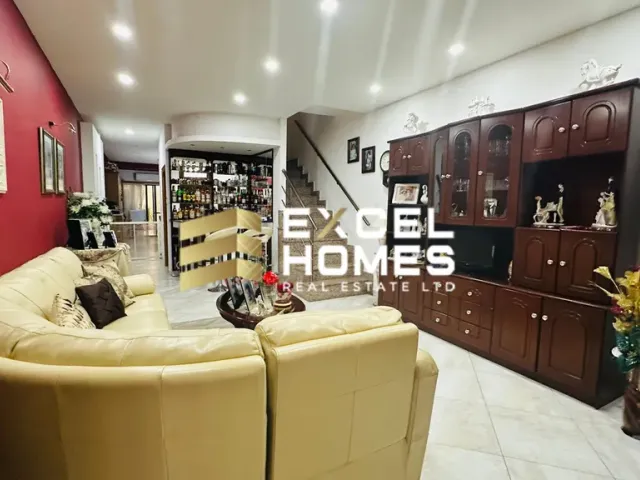 a living room with a couch, coffee table and a television