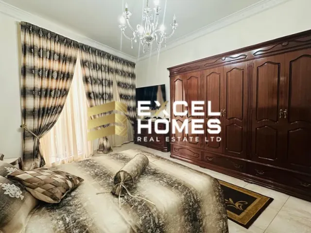 a bedroom with a bed, a dresser, and a painting on the wall