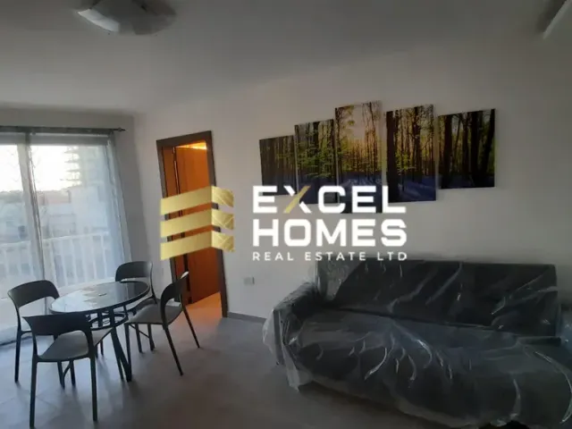 a living room with a couch, coffee table and a television